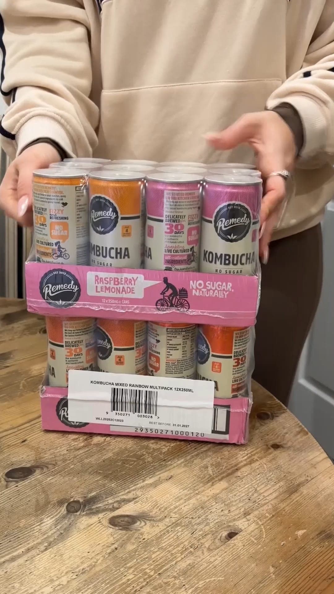 A creator unwrapping two multipacks of Remedy kombucha